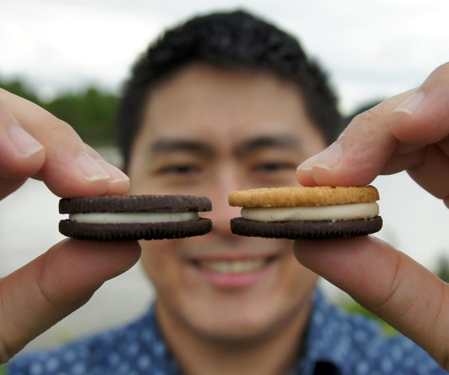 A Janus monolayer has different atoms on top and bottom, like the sandwich cookie at right held by ORNL materials scientist Yu-Chuan Lin. Credit: Christopher Rouleau/ORNL, U.S. Dept. of Energy