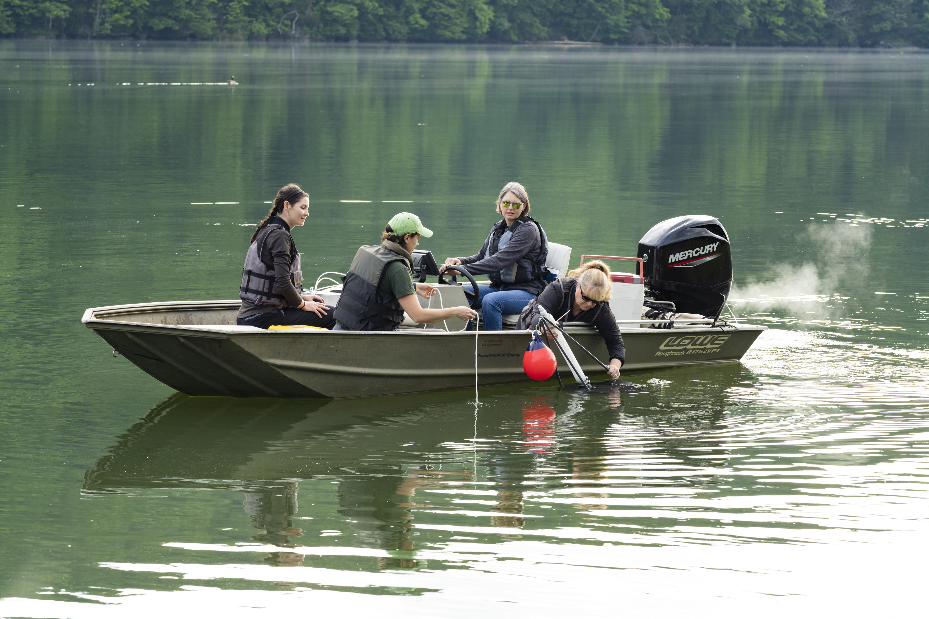 Natalie Griffiths and team pulling bubble traps on lake