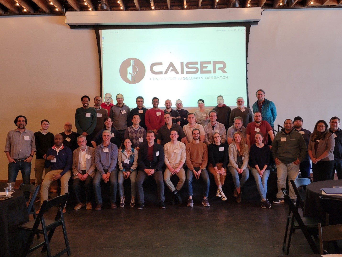 Caption: Participants gather for a group photo after discussing securing AI systems for critical national security data and applications.  Photo by Liz Neunsinger/ORNL, U.S. Dept. of Energy