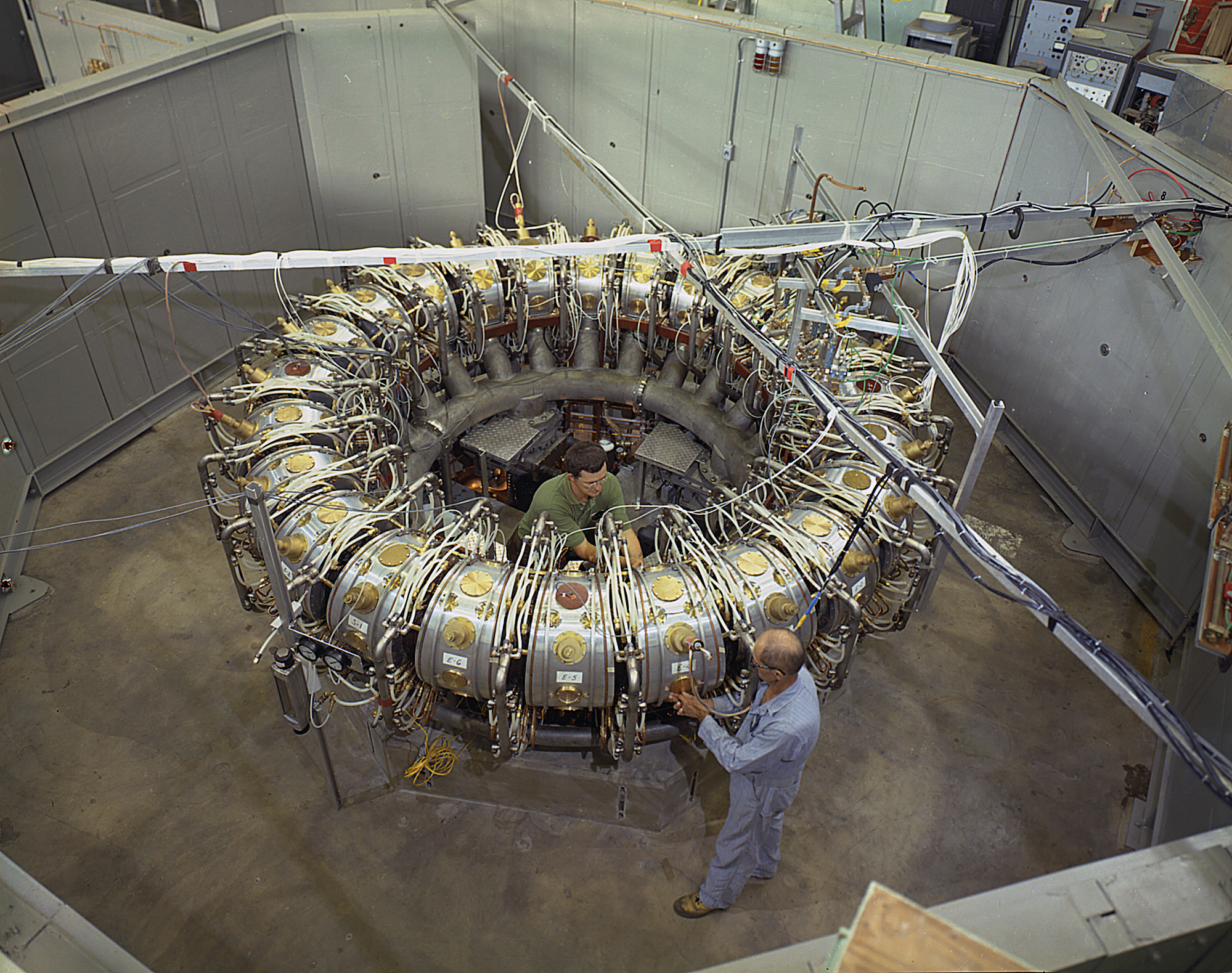 A circular fusion device called EBT with a technician operating on one of the sides