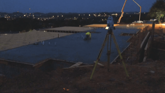 gif of leveling tool taking laser measurements of concrete pad at night