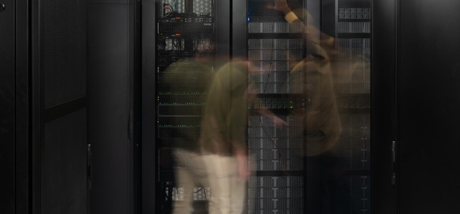 Blurred image of two men in front of ARM cluster.