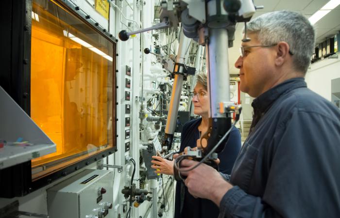 Radiochemical technicians David Denton and Karen Murphy use hot cell manipulators at Oak Ridge National Laboratory during the production of actinium-227.