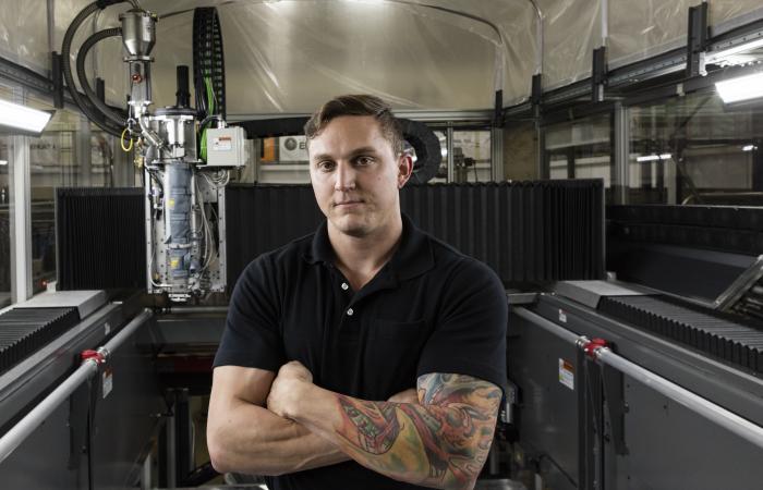 Matt Sallas standing inside large 3D printer
