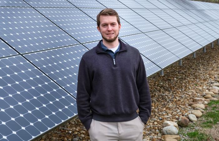 Ben Ollis standing in front of the ORNL Solar Array