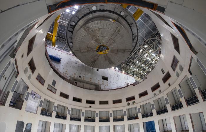 The 1250 ton cyrostat base is positioned over the ITER tokamak pit for installation. This base is the heaviest lift of tokamak assembly. Credit: ITER Organization