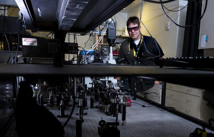 ORNL’s Benjamin Doughty stands behind the laser-enabled microscope. Credit: Carlos Jones/ORNL, U.S. Dept. of Energy