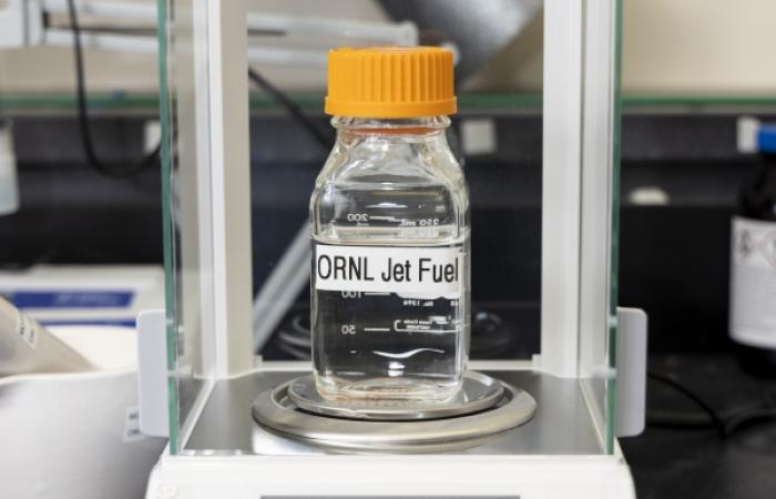 Li weighs a sample of jet fuel that was converted from ethanol using a process he invented that has been licensed by Prometheus Fuels. Credit: Carlos Jones/ORNL, U.S. Dept. of Energy 