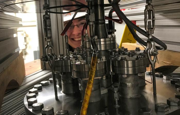 Indiana University physics undergraduate Maria del Valle Coello views the CENNS-10 detector installed in SNS's Neutrino Alley. Credit: Rex Tayloe/Indiana University