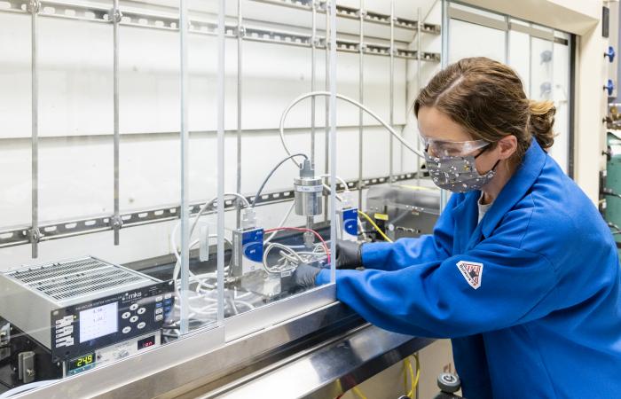 Brenda Smith, shown here working with a gas viscometer in her research lab, is one of several people concurrently researching the thermophysical properties of feedstock gas. Their research will support computational researchers who are designing processes to separate isotopes. Credit: Carlos Jones/ORNL, US Dept. of Energy