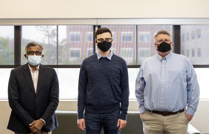 From left, ORNL Director Thomas Zacharia, Tyler Duckworth and Robert Duckworth pose for a portrait.  Tyler Duckworth has been named recipient of the 2021 UT-Battelle Scholarship to attend the University of Tennessee. Credit: Carlos Jones/ORNL, U.S. Dept. of Energy