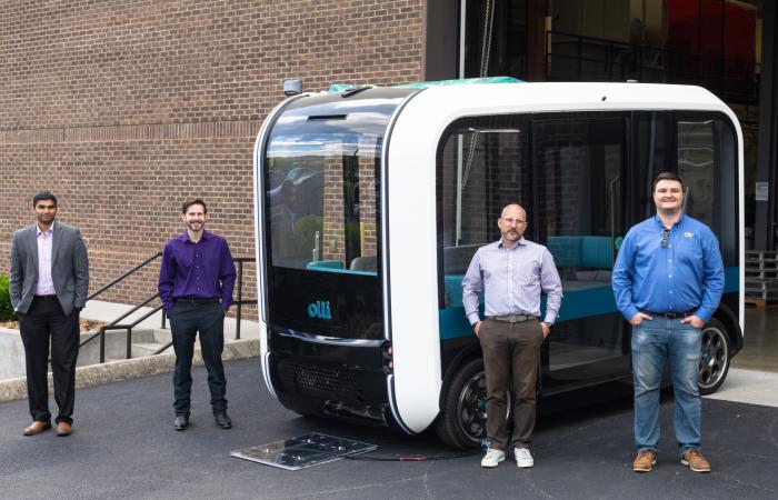 From left, ORNL’s Madhu Chinthavali and Steven Campbell with Local Motors’ Johnny Scotello and Seth Schofill demonstrated the Olli autonomous bus, which is equipped with the lab’s wireless charging technology. Credit: Carlos Jones/ORNL, U.S. Dept. of Energy