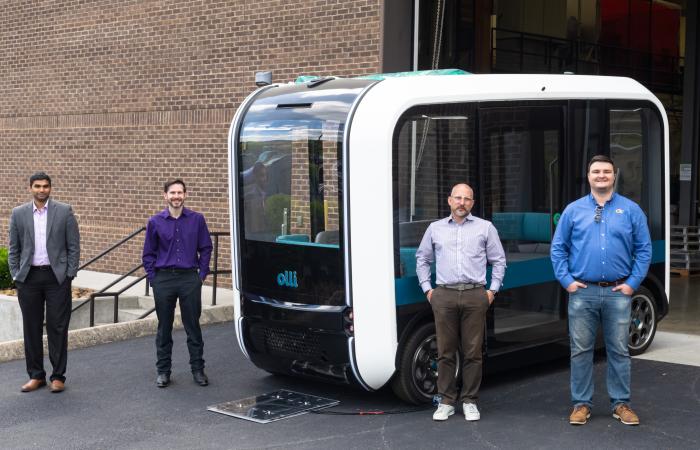 From left, ORNL's Madhu Chinthavali and Steven Campbell with Local Motors' Johnny Scotello and Seth Schofill demonstrated the Olli autonomous bus, which is equipped with the lab's wireless charging technology. Credit: Carlos Jones/ORNL, U.S. Dept. of Energy