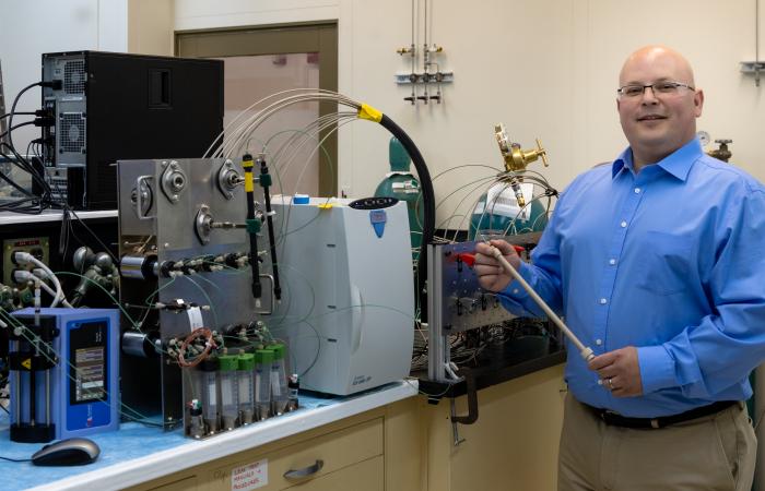 Chemist Kevin Gaddis built a control panel for the HPIC that uses air pressure instead of  electronics, so that it can used inside a hot cell during the processing of actinium-225. Credit: Carlos Jones/ORNL, U.S. Dept. of Energy