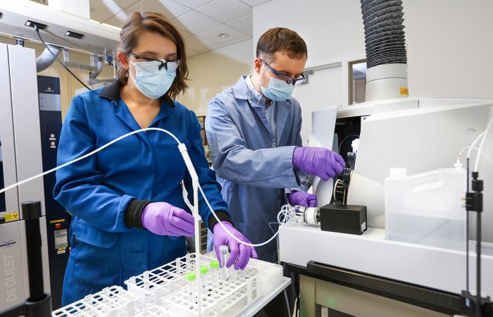 Santa Jansone-Popova, left, and Ilja Popovs quantify rare-earth element concentrations in liquid samples using a spectroscopy instrument. The pair are part of a research team that developed a new technology for rare-earth elements chemical separation that has been licensed to Marshallton Research Laboratories. Credit: Genevieve Martin/ORNL, U.S. Dept. of Energy 