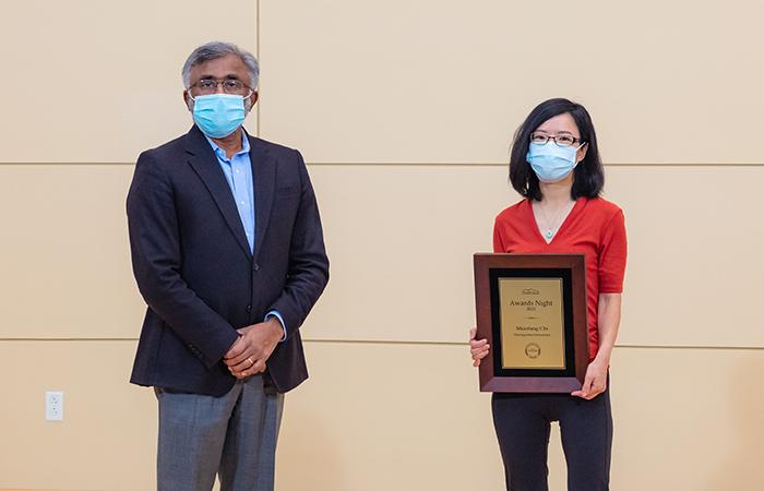 ORNL Director Thomas Zacharia presents Miaofang Chi, with a plaque for receiving the 2021 Director's Award for Outstanding Individual Accomplishment in Science and Technology on Dec. 10, 2021. Credit: Carlos Jones/ORNL, U.S. Dept. of Energy