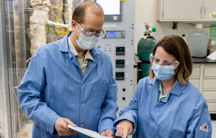 ORNL’s Bruce Pint, left, and Marie Romedenne review experiment results. Credit: ORNL, U.S. Dept. of Energy