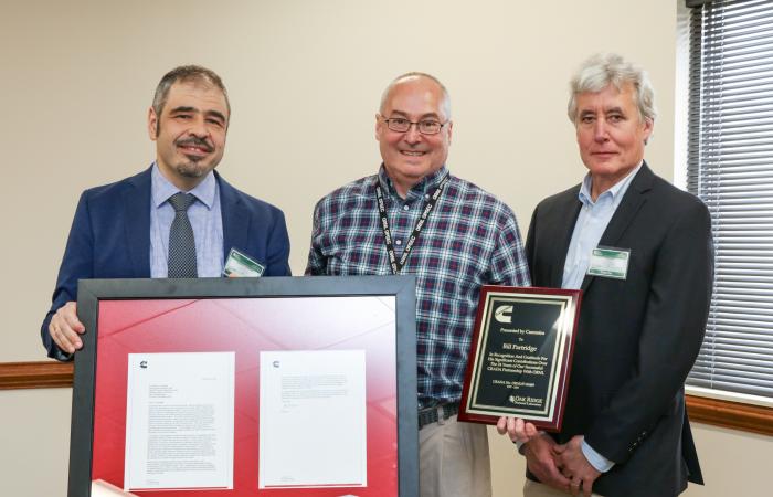ORNL’s Bill Partridge, applied catalysis and emissions researcher, accepted project recognition awards from Aleksey Yezerets, left, Cummins catalyst technology director, and Tim Lutz, right, Cummins engine optimization manager. Credit: ORNL, U.S. Dept. of Energy