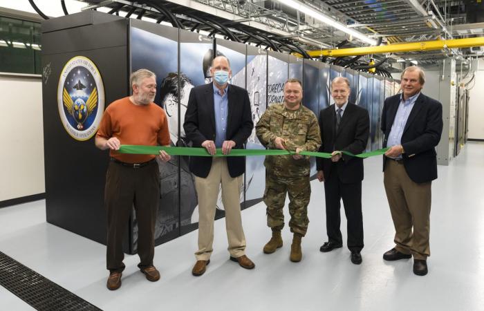 Five men in front of Air Force Weather Supercomputer