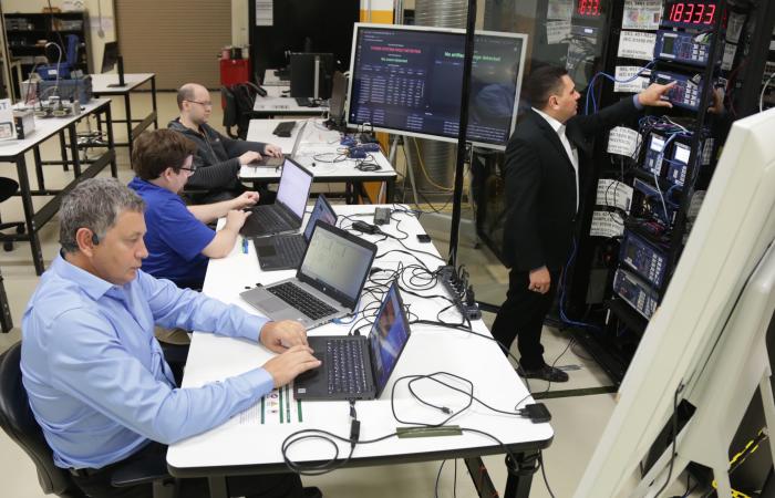 Emilio Piesciorovsky, Aaron Werth, Gary Hahn and Raymond Borges Hink test their blockchain-based validation system for grid communications in the Department of Energy’s Grid Research and Integration Deployment Center, or GRID-C, at ORNL. Credit: Genevieve Martin/ORNL, U.S. Dept. of Energy