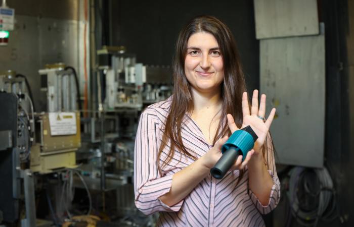 Oak Ridge National Laboratory’s Leah Broussard shows a neutron-absorbing "wall" that stops all neutrons but in theory would allow hypothetical mirror neutrons to pass through. Credit: Genevieve Martin/ORNL, U.S. Dept. of Energy