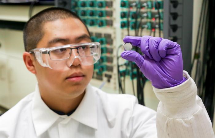 ORNL postdoctoral researcher Runming Tao, pictured with a coin cell battery, led an effort to discover new anode materials for fast-charging lithium-ion batteries. Credit: ORNL/Genevieve Martin, U.S. Dept. of Energy