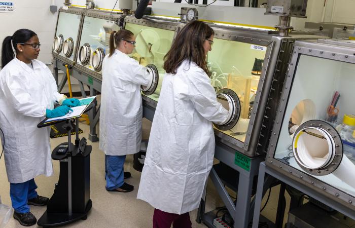 Scientists work in a glovebox in the Radiochemical Engineering and Development Center, or REDC,  at ORNL’s main campus. The REDC provides world-class capabilities in isotope production, research and development, source fabrication, and the distribution of various unique isotopes. Here, experts handle some of the most exotic materials in the world. Credit: Carlos Jones, ORNL/U.S. Dept. of Energy