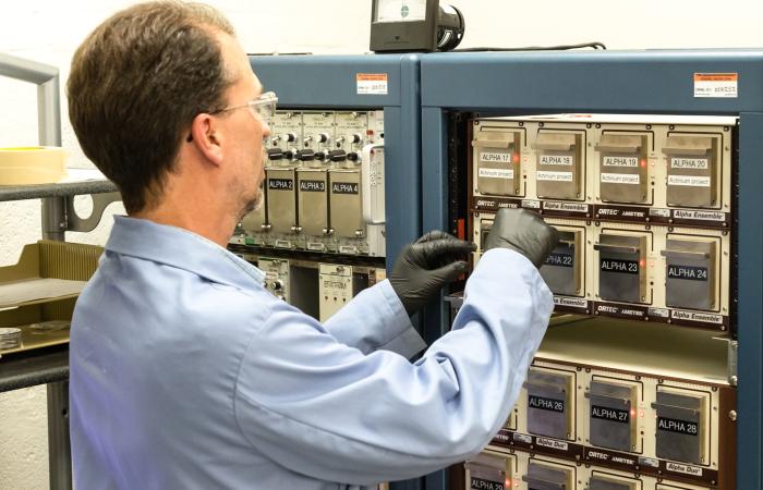 Marc Chattin of Oak Ridge National Laboratory uses an alpha spectrometer to analyze samples of isotopic plutonium with an ISO 17025-accredited method. Credit: Carlos Jones/ORNL, U.S. Dept. of Energy
