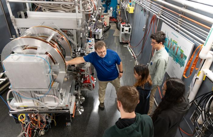 Students get acquainted with the Neutron Spin Echo instrument at SNS that specializes in studying molecular motion to better understand the dynamics of polymers, complex fluids and other biological materials such as proteins, enzymes, and membranes. Credit: Genevieve Martin/ORNL, U.S. Dept. of Energy