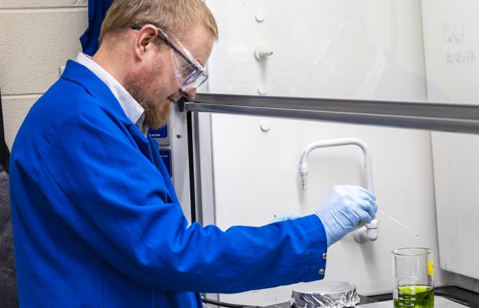 Alexey Serov conducts a chemical experiment to make a new form of hydrogen fuel cell catalyst that uses nickel, iron and other materials instead of rare, expensive platinum group metals. Credit: Carlos Jones/ORNL, U.S. Dept. of Energy