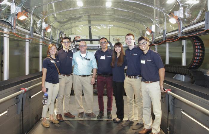 ORNL’s Lonnie Love hosted a University of Illinois at Urbana-Champaign student engineering team who watched their award-winning excavator cab design being printed on the Big Area Additive Manufacturing system at DOE’s Manufacturing Demonstration Facility 