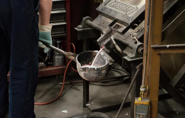 Alloyed metals being poured from a furnace into a ladle, to be used to fill molds. Image credit: Zachary Sims, ORNL