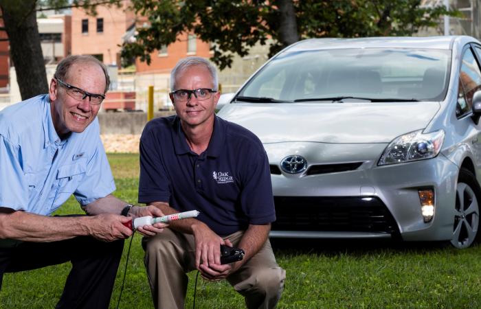 ORNL inventors Bruce Warmack, left, and Nance Ericson display an early prototype of the DC hotstick. Credit: Carlos Jones/Oak Ridge National Laboratory, U.S. Dept. of Energy.