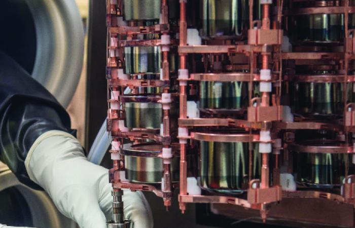 Several of the DEMONSTRATOR’s 58 hockey-puck-sized detectors are assembled in strings, and several strings are placed in each of the experiment’s 2 cryostats. Yu works on the intricate assemblies in a nitrogen-filled glove box that provides a challenge: “