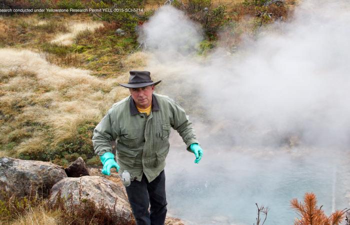 Podar holds a sample taken from a nearby thermal pool in Yellowstone National Park.