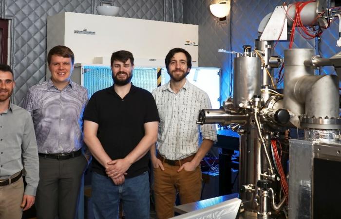 Eugene Dumitrescu, Ben Lawrie, Matthew Feldman, and Jordan Hachtel (from left) have conducted investigations aimed at controlling the dissipative nature of quantum systems and materials. The cathodoluminescence microscope used in their work appears at rig