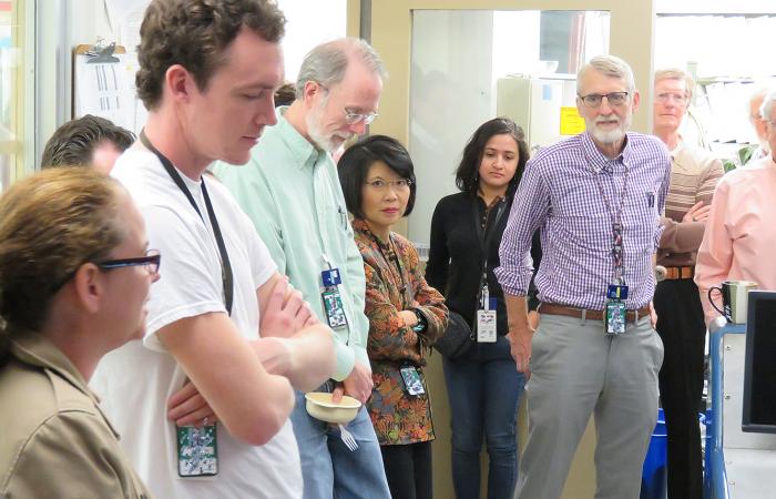 Physics Division staff members and retirees gather at a ceremony marking the March 31 conclusion of the tandem experiments. 