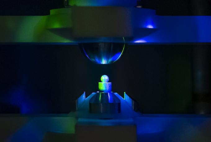 Creep Electrostatic Levitator, pictured here with a round aluminum test sample in the center, is designed to levitate and laser-heat conductive samples while rotating them at high speeds