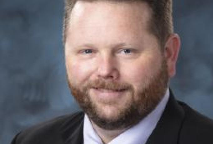 Portrait of a bearded man smiling at the camera