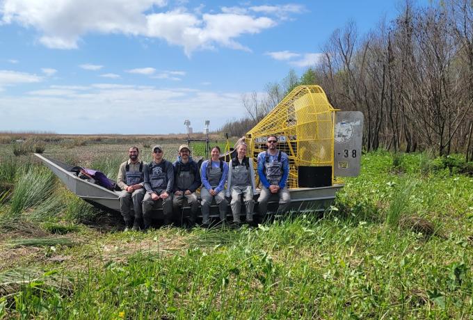 researchers posing in the field
