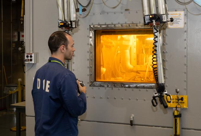 James Gaugler works with manipulators at the hot cell to produce radium pellets