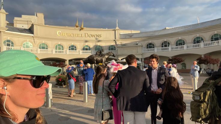 Angela Lousteau takes a selfie in front of Churchill Downs at the Kentucky Derby