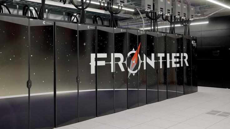 Photo of the front row of the Frontier supercomputer showing the Frontier logo. 