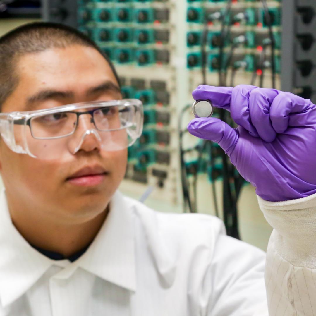 ORNL postdoctoral researcher Runming Tao, pictured with a coin cell battery, led an effort to discover new anode materials for fast-charging lithium-ion batteries. Credit: ORNL/Genevieve Martin, U.S. Dept. of Energy