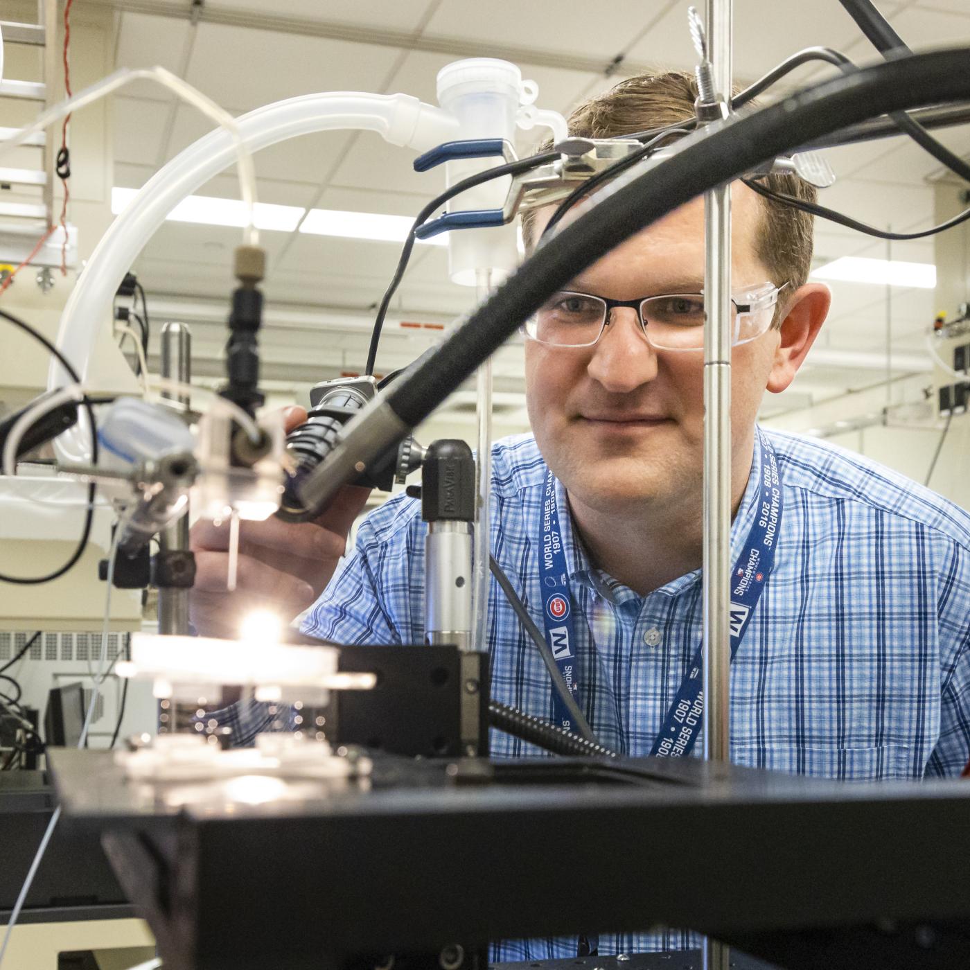 Jack Cahill of ORNL’s Biosciences Division is developing new techniques to view and measure the previously unseen to better understand important chemical processes at play in plant-microbe interactions and in human health. In this photo, Cahill is positioning a rhizosphere-on-a-chip platform for imaging by mass spectrometry. Credit: Carlos Jones/ORNL, U.S. Dept of Energy