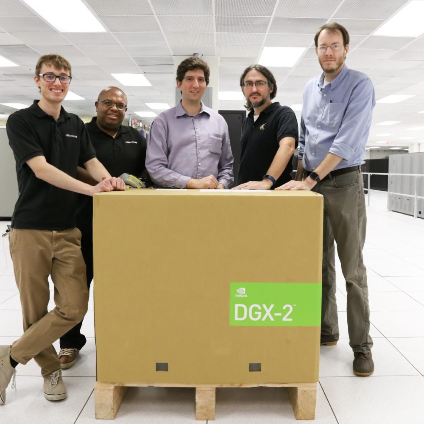 Five men standing behind a large box