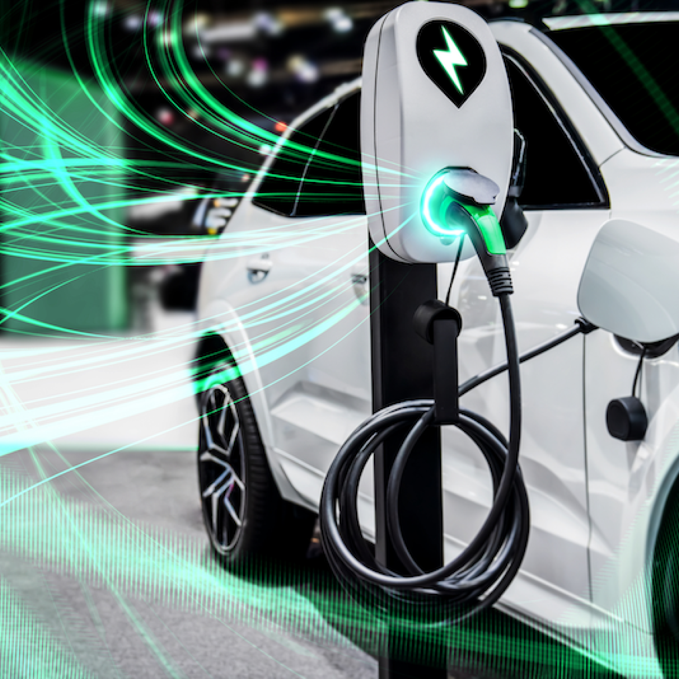 White electric vehicle connected to charger