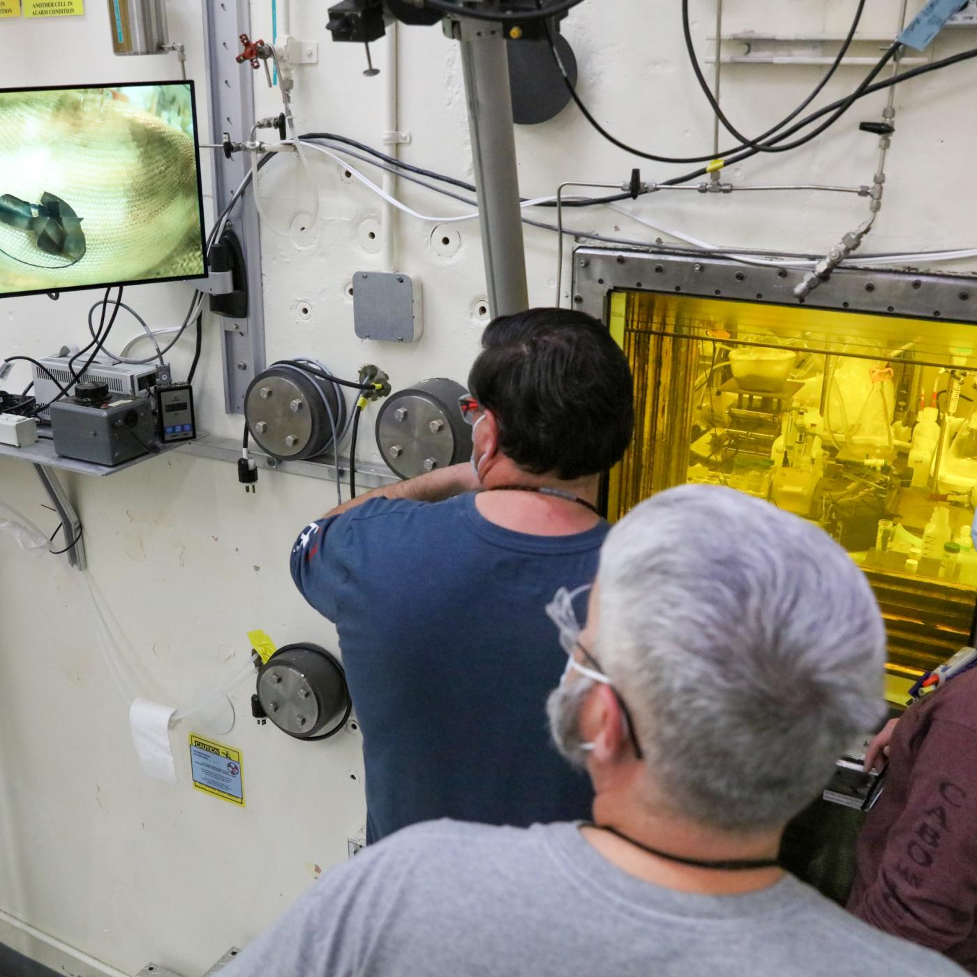 David Denton, Lance Wyant (on manipulator) and Cassandra Fike-Hanley prepare irradiated thorium target segments for dissolution. That processing will separate out actinium-225, which will then be packaged for customers. Credit: Genevieve Martin/ORNL, U.S. Dept. of Energy