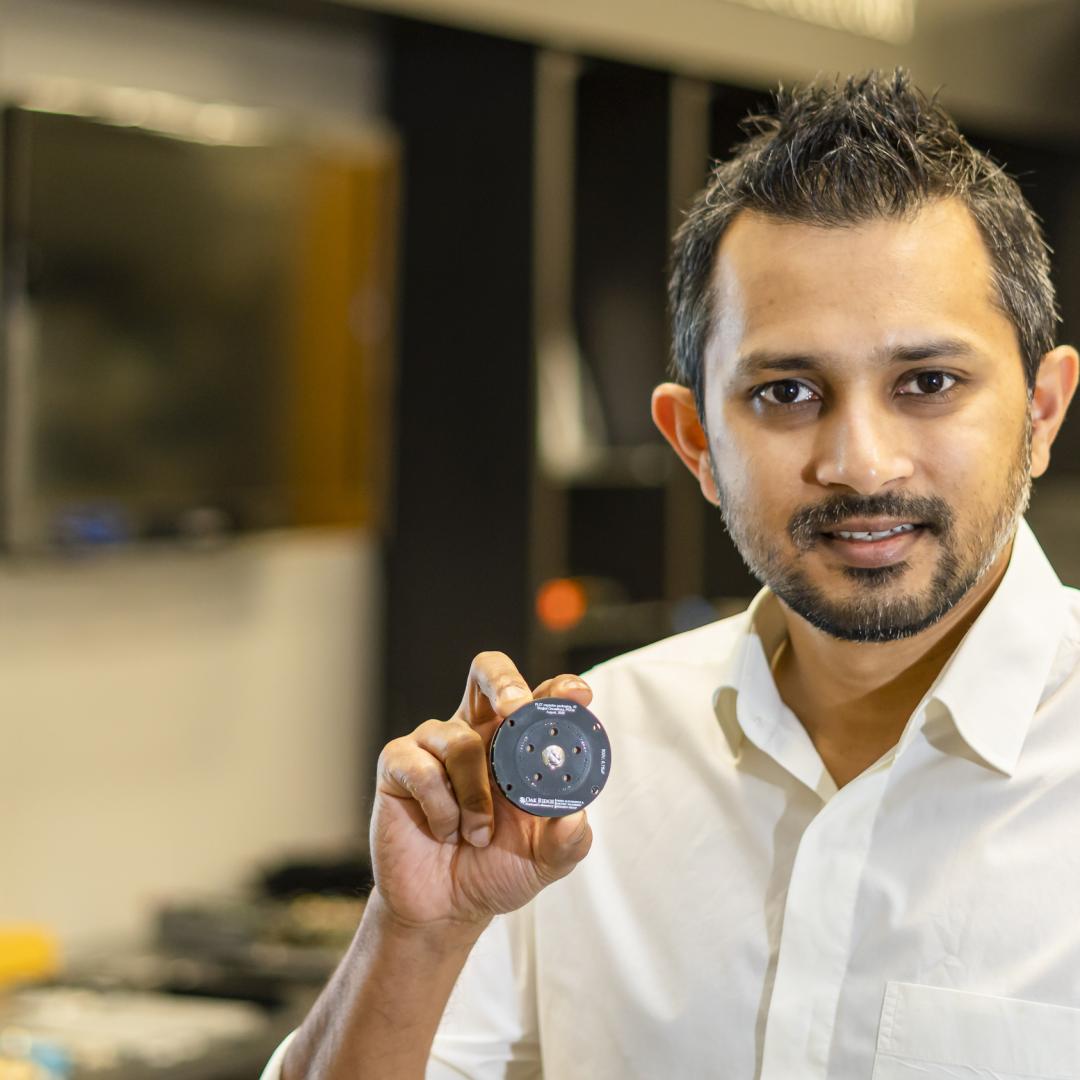 Shajjad Chowdhury, an ORNL power electronics researcher, is designing a more compact and power-dense capacitor that will help maximize electric vehicle driving range. Credit: Carlos Jones/ORNL, U.S. Dept. of Energy
