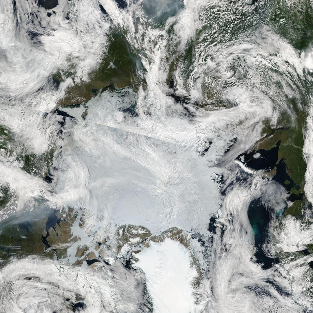 Clouds of gray smoke in the lower left are funneled northward from wildfires in Western Canada, reaching the edge of the sea ice covering the Arctic Ocean. A second path of thick smoke is visible at the top center of the image, emanating from wildfires in the boreal areas of Russia’s Far East, in this image captured on July 13, 2023. Credit: NASA MODIS